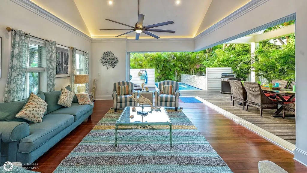 Airy living room opening to a tropical covered lanai