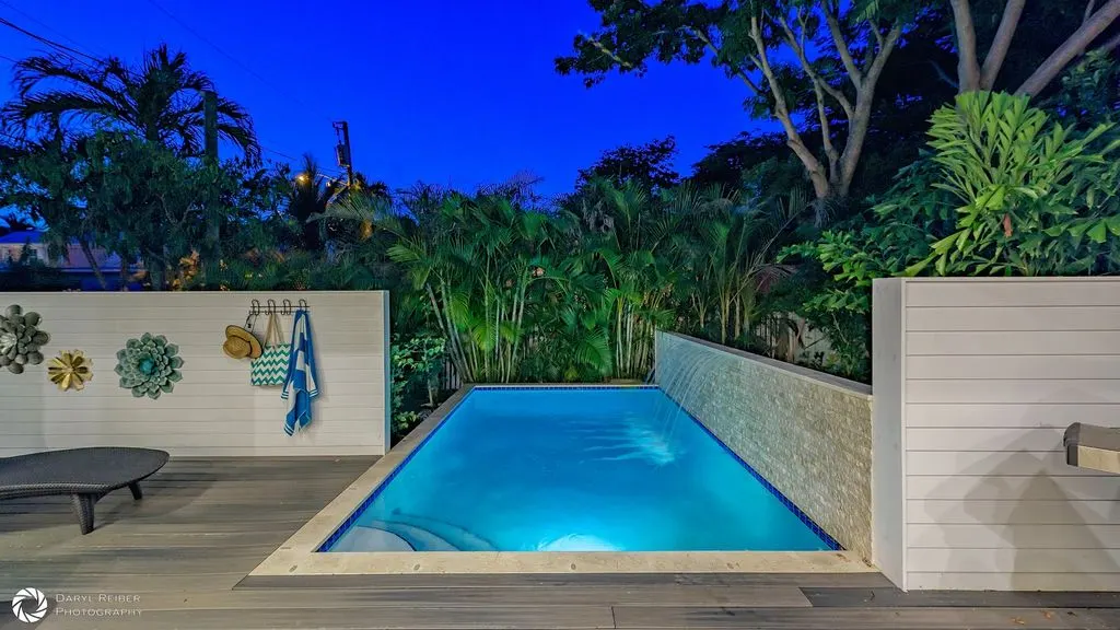 Private pool glowing blue at night